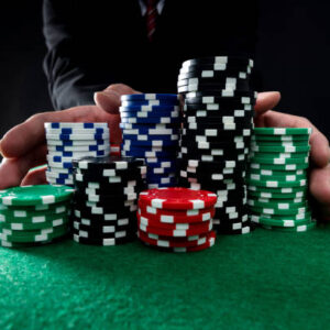 Businessman hands pushing gambling chips.